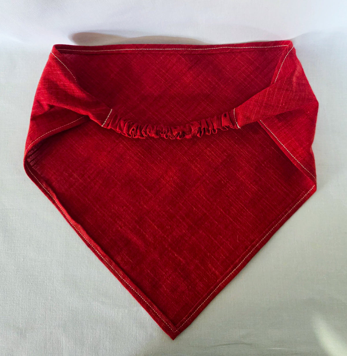 red hair bandana laid flat, showing the elastic band. 